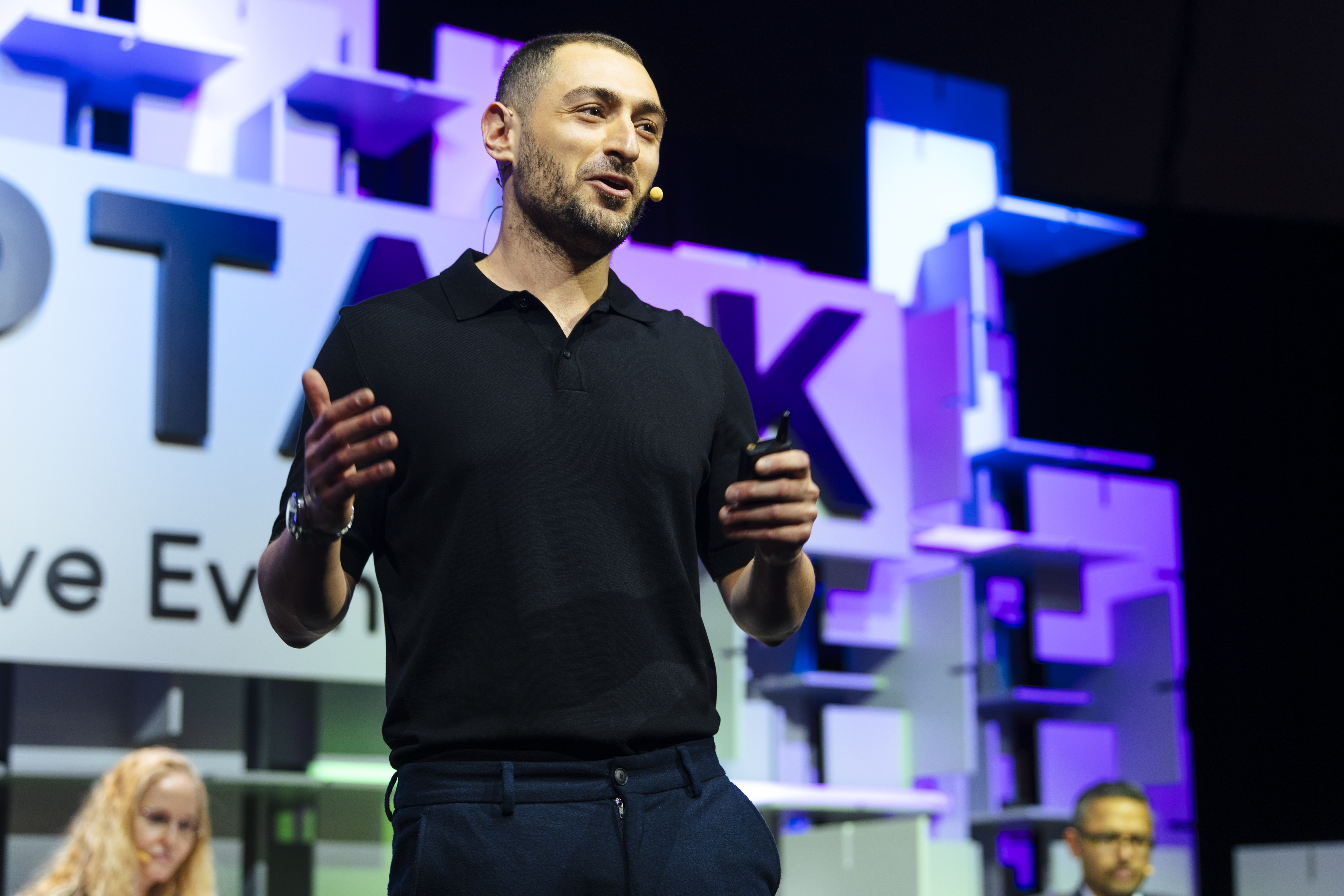 Max Sinclair speaking on stage